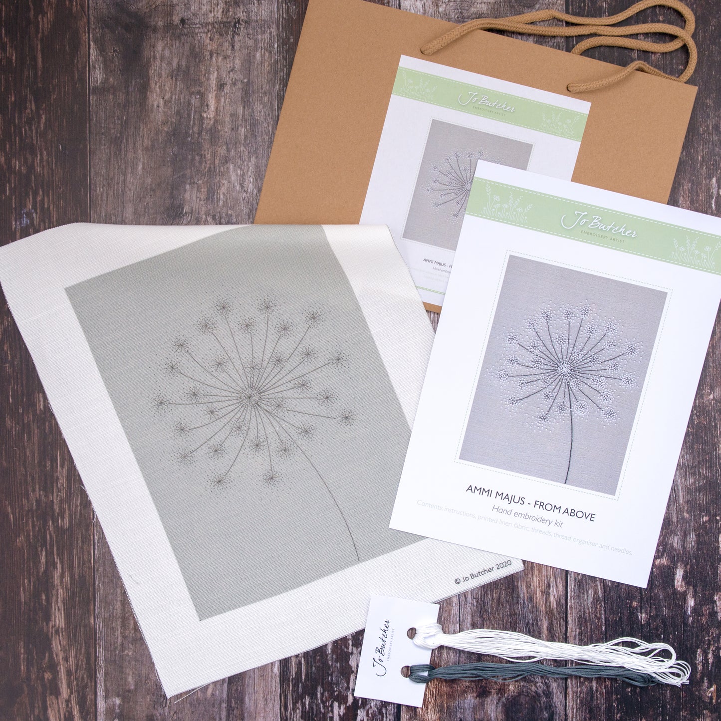 Kit contents - Printed cotton/linen background, threads, instruction sheet and brown paper bag.