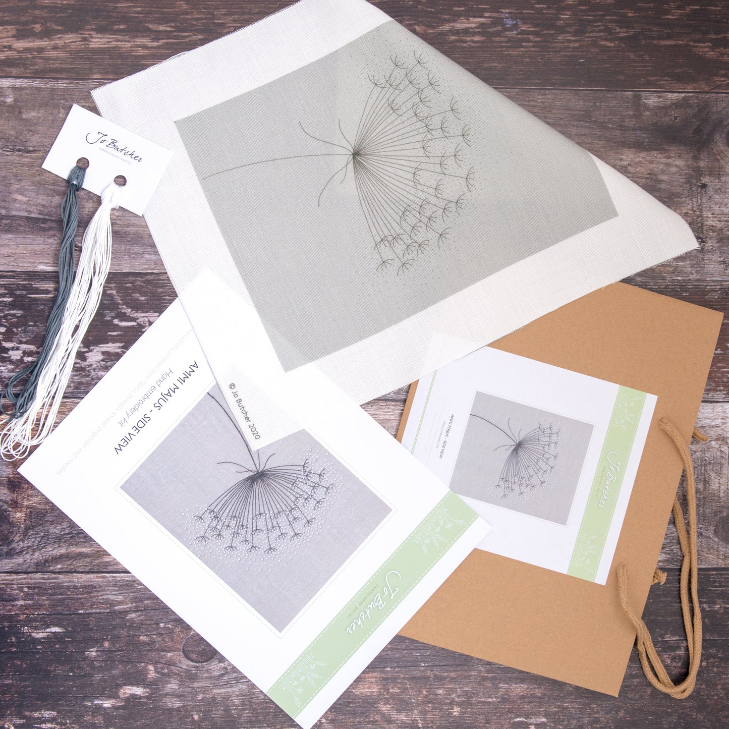 Kit contents - Printed cotton/linen background, threads, instruction sheet and brown paper bag.