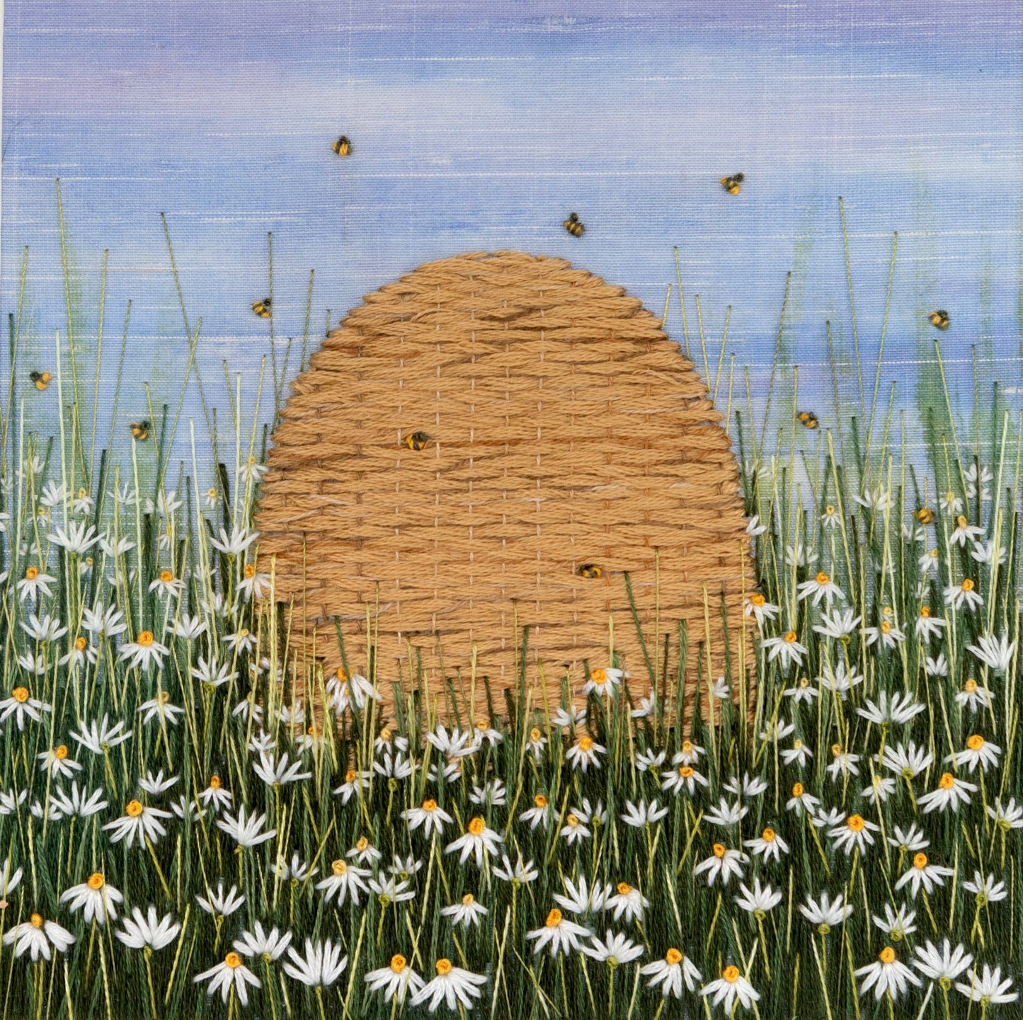 embroidered bee skep and bees in a field of white daisies