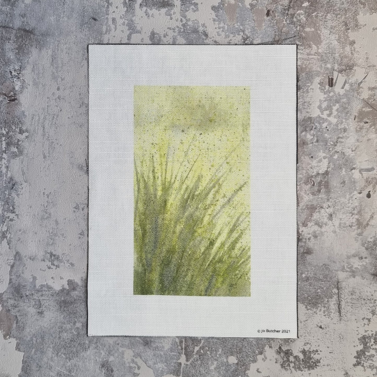 a rectangle of cotton linen with a printed yellow background with green foreground