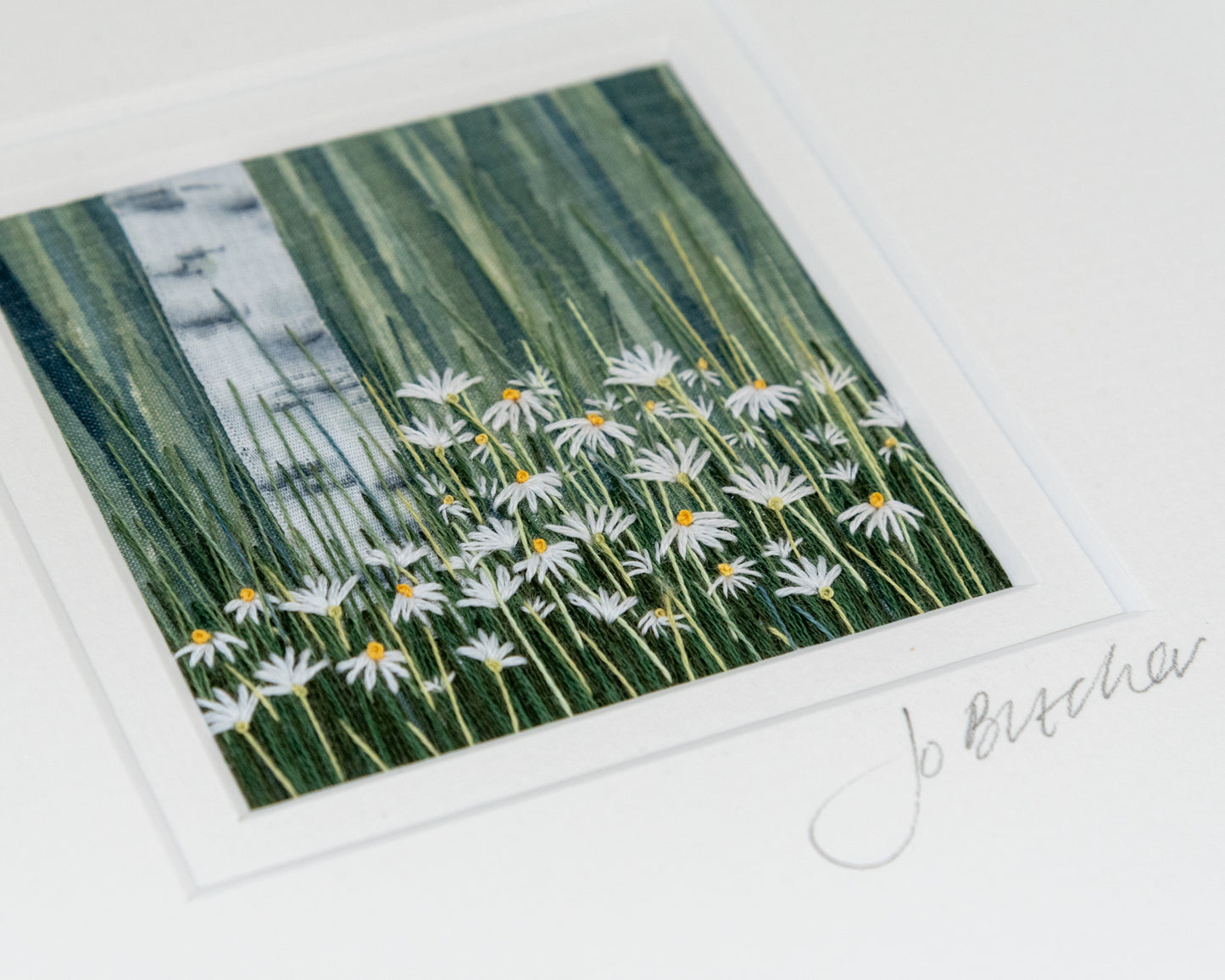 hand painted background in shades of grey/green set of this silver birch tree trunk made of hand painted silk ribbon rising above white daisies.