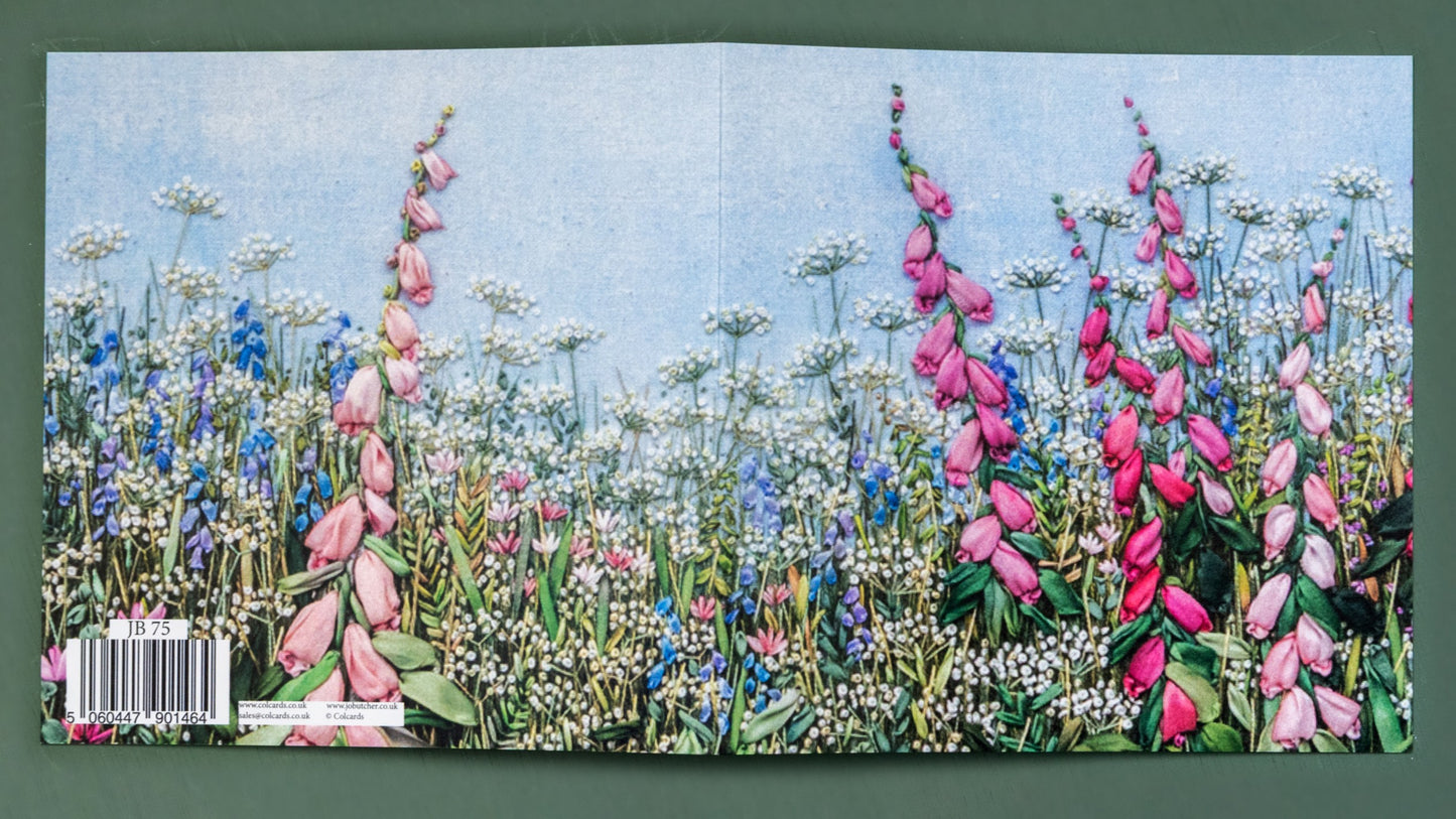 open printed card showing the full image of pink foxgloves among small blue flowers and cow parsley.