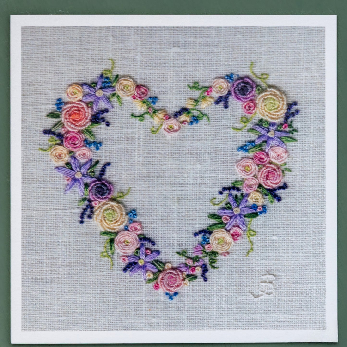 A colourful hand embroidered flower heart.