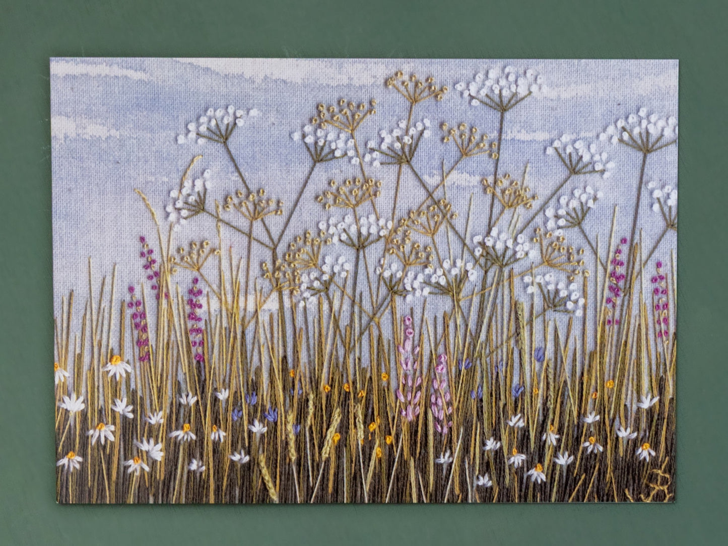 Hand embroidered classic of a rabbit's eye view of a meadow.
