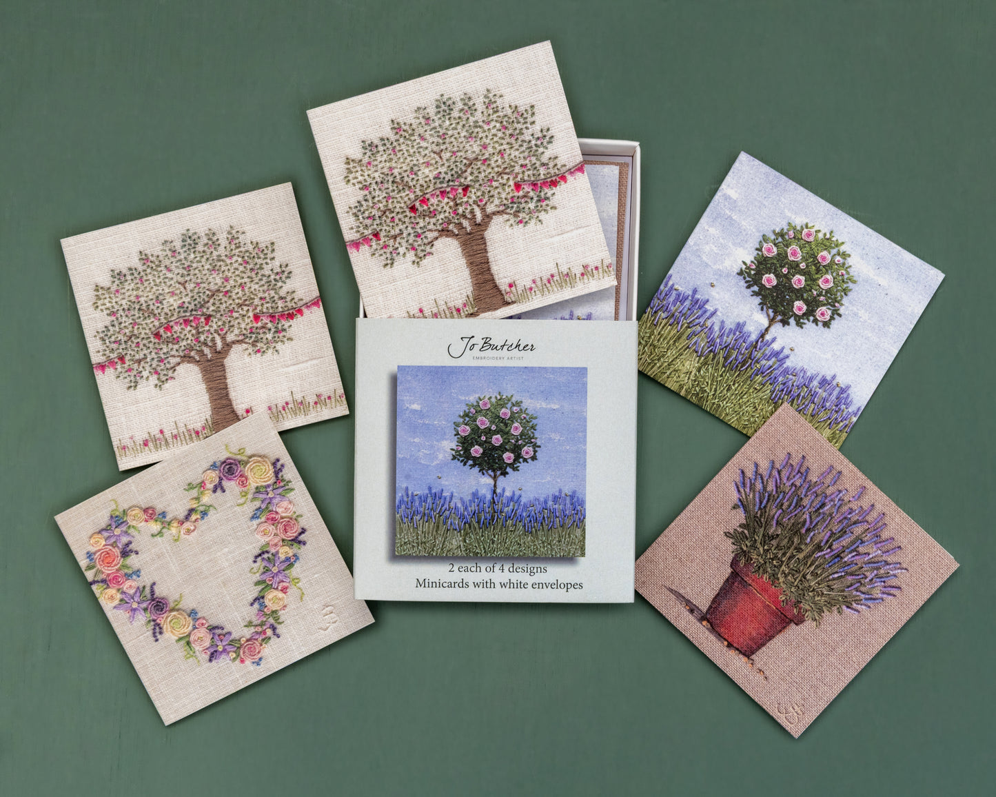 Open box of small square cards with the 4 different designs around the side.