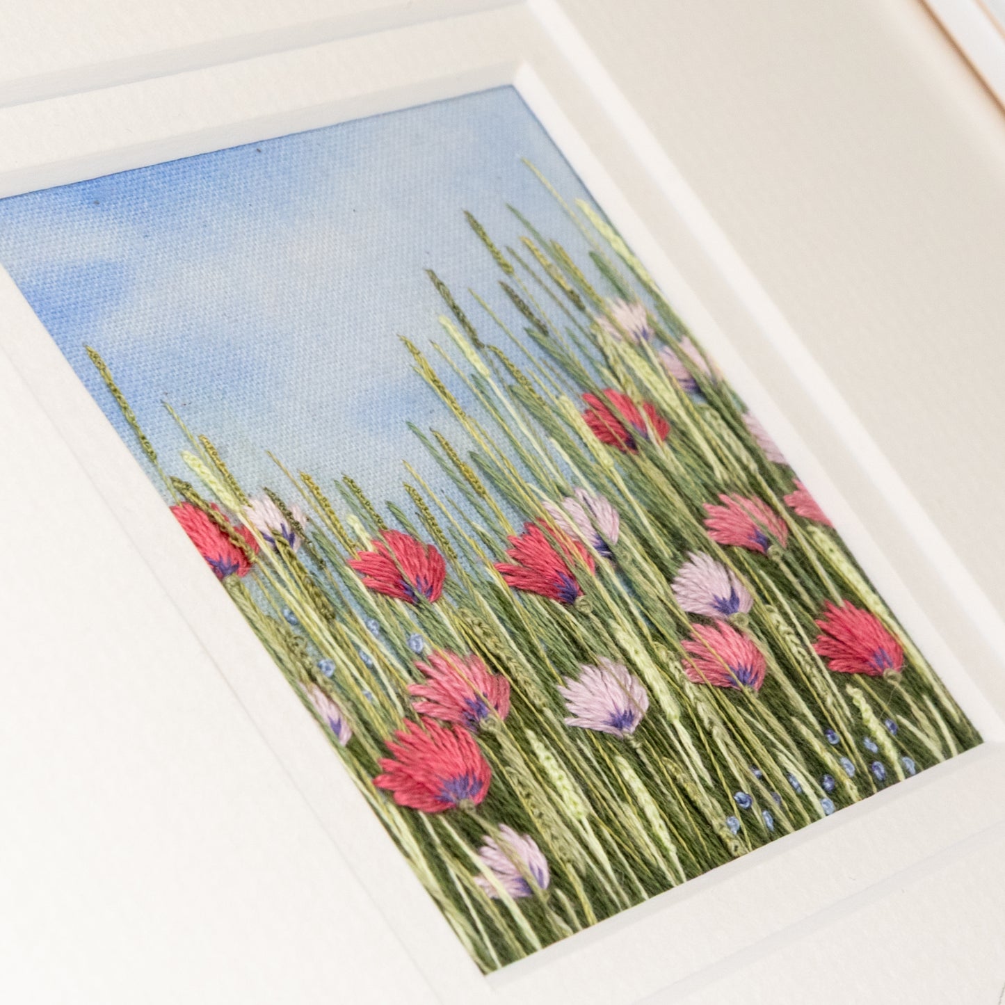 View across the stiches to show the texture of this embroidered flower meadow.