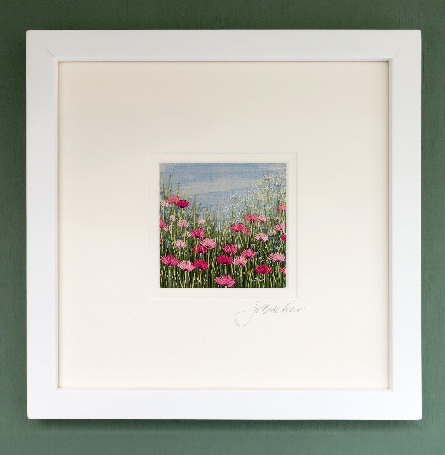 White framed artwork of a pink poppy meadow with cow parsley and a few small blue flowers.
