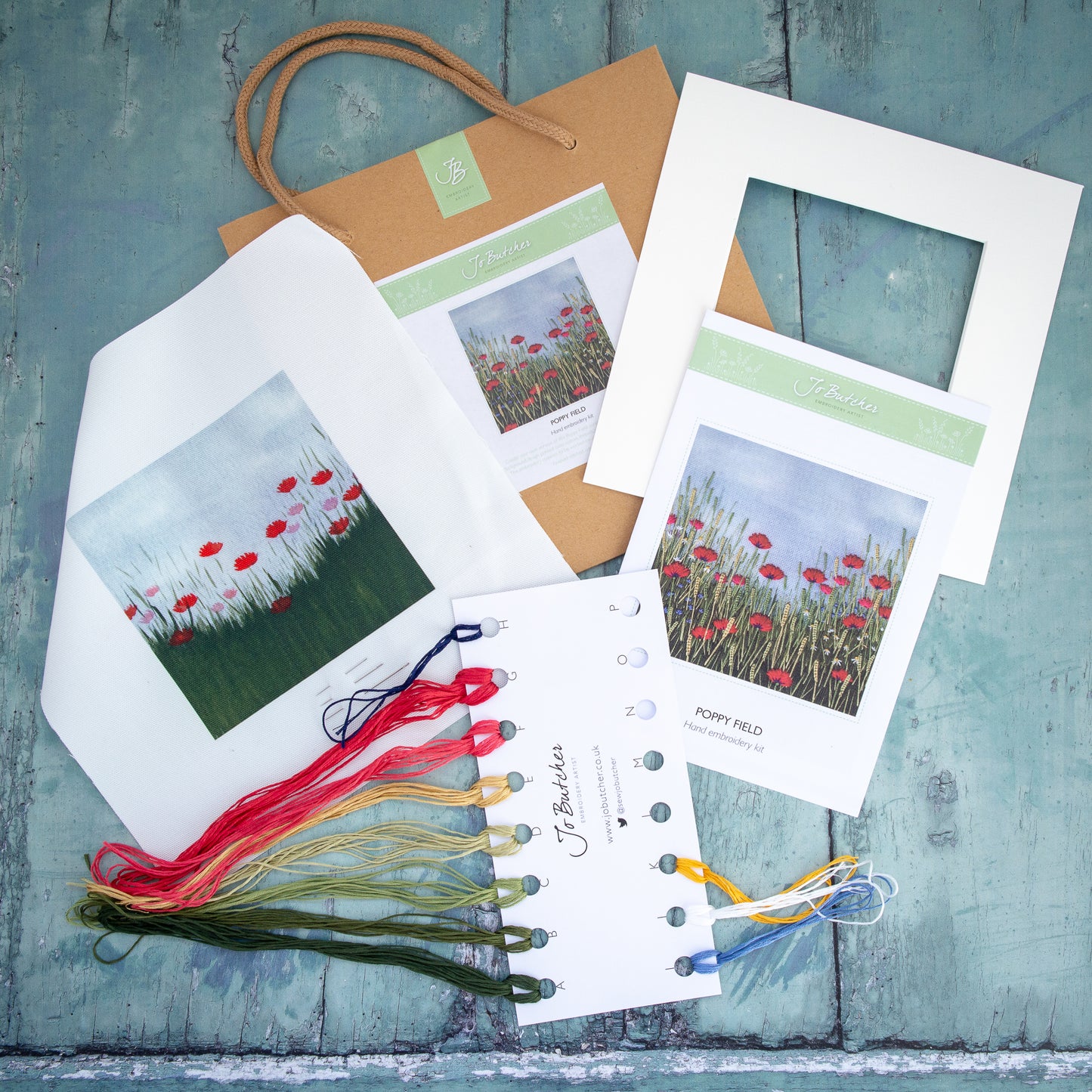 printed background, threads, mount, and step by step instruction and the brown paper bag they come in.