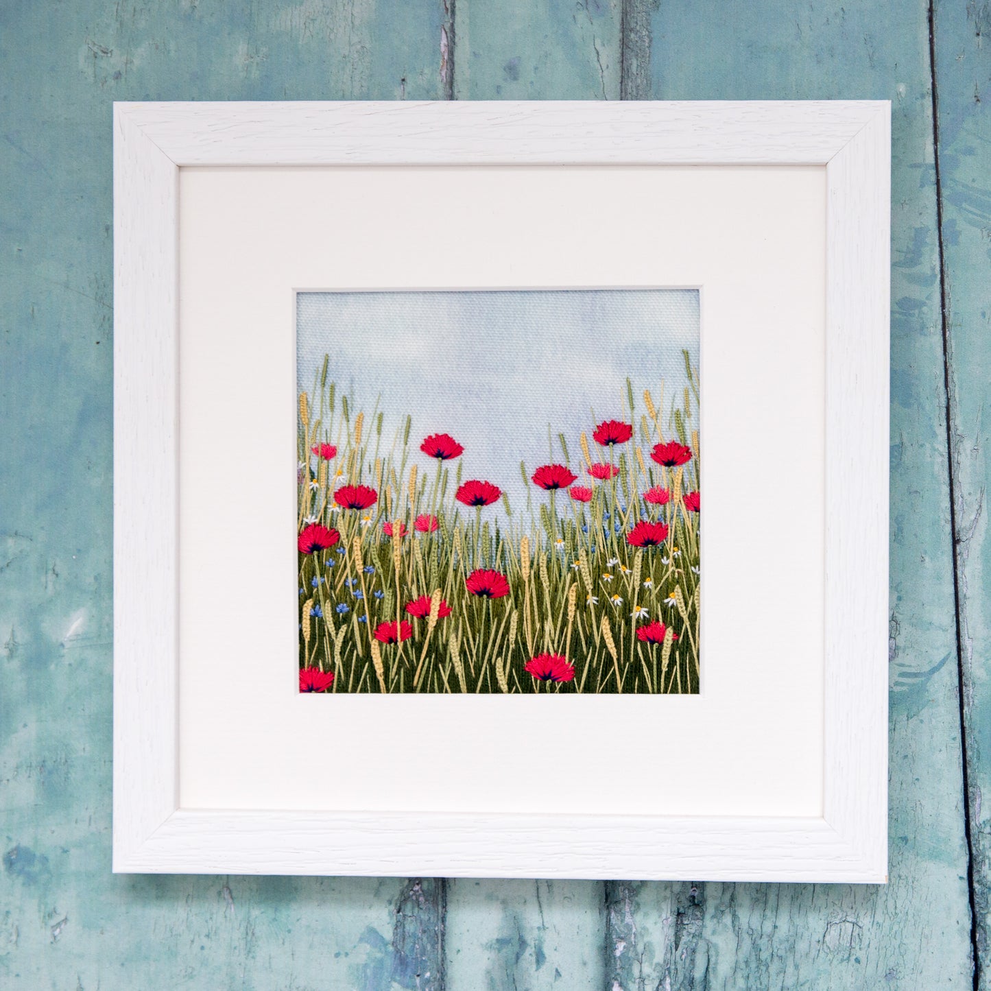 Completed kit in a white square frame and mount.