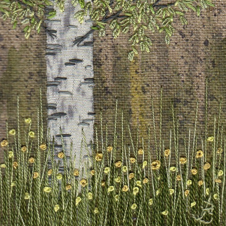 Hand embroidery artwork of Buttercups flowering in the shade of a silver birch  tree