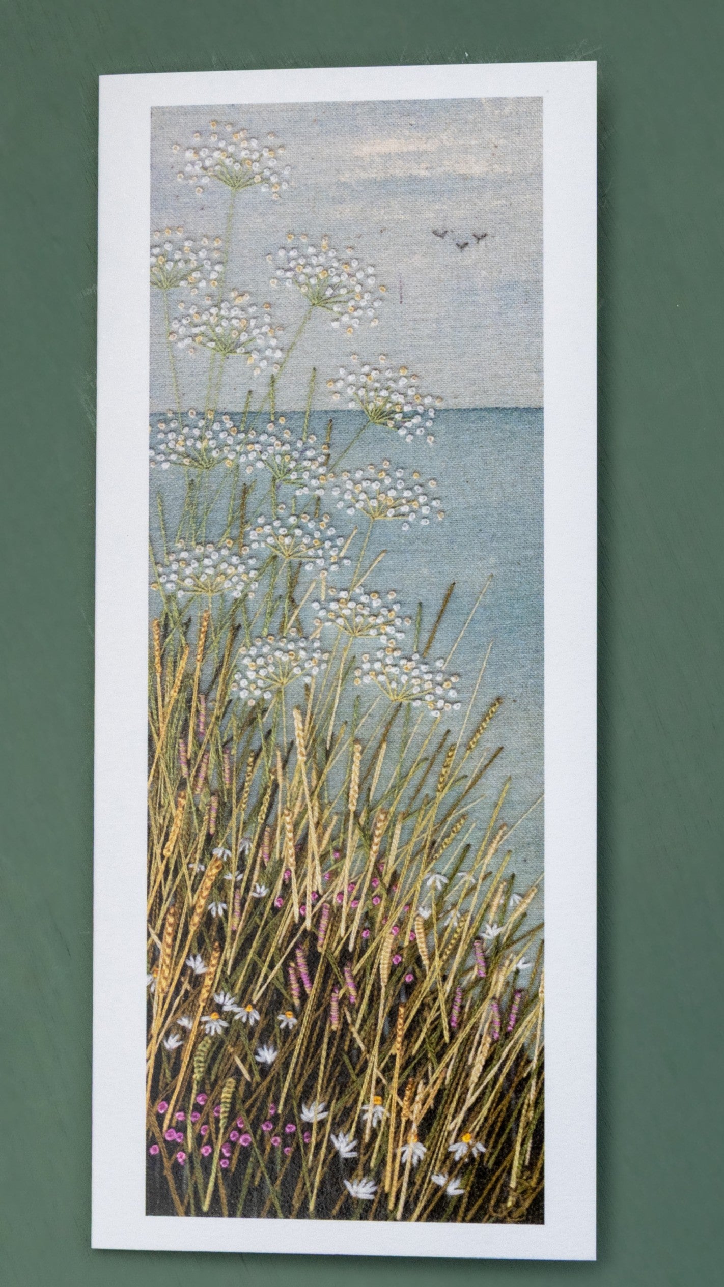 Upright card of a cliff top coastal scene.