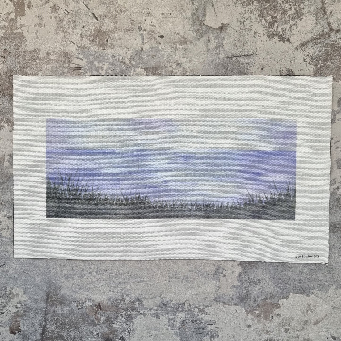A printed cotton linen rectangle with the view f the horizon from a cliff with grasses printed in the lower third on the image for sewing over.