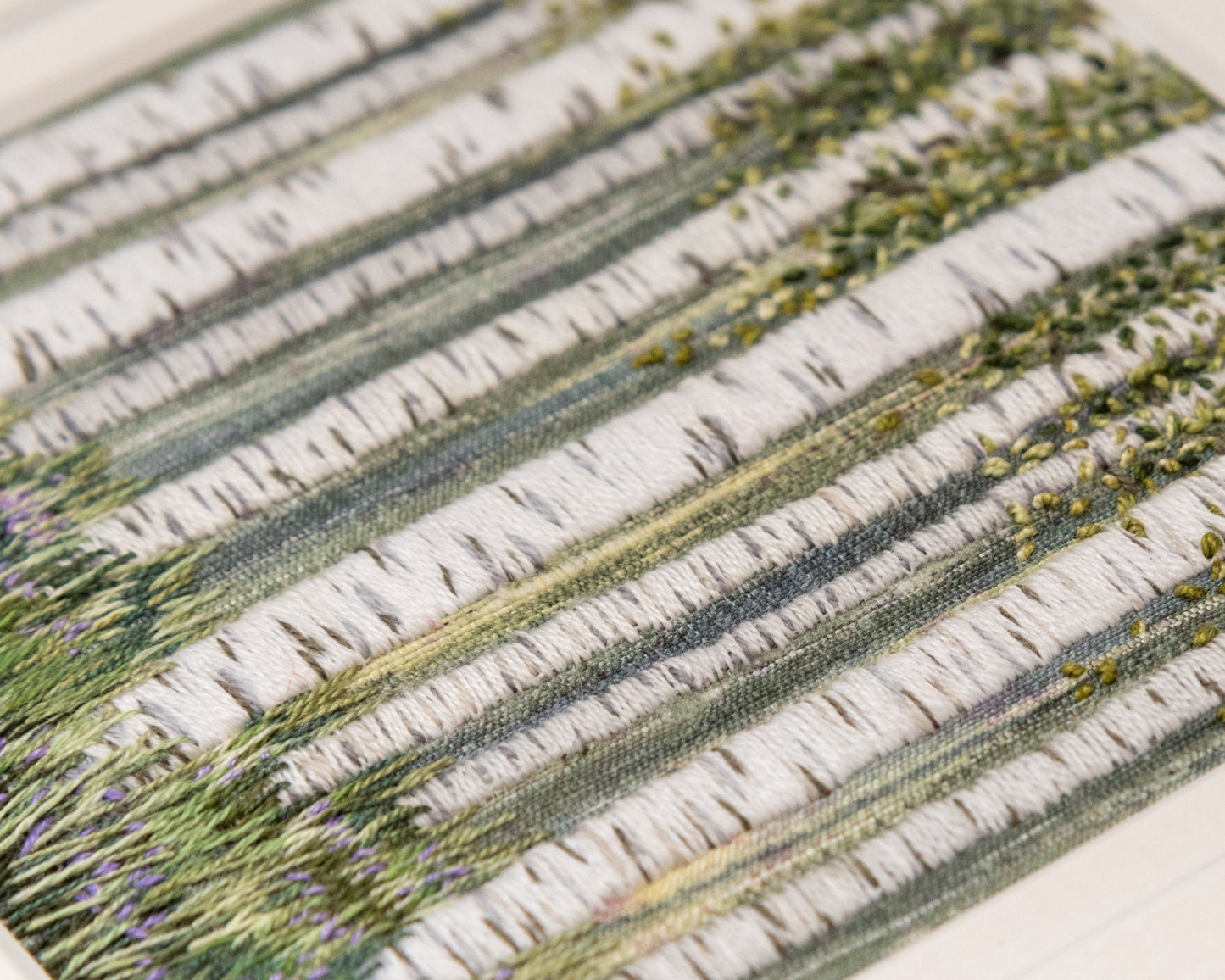 The detailed stitches of the tree and leaves can be seen in this image.