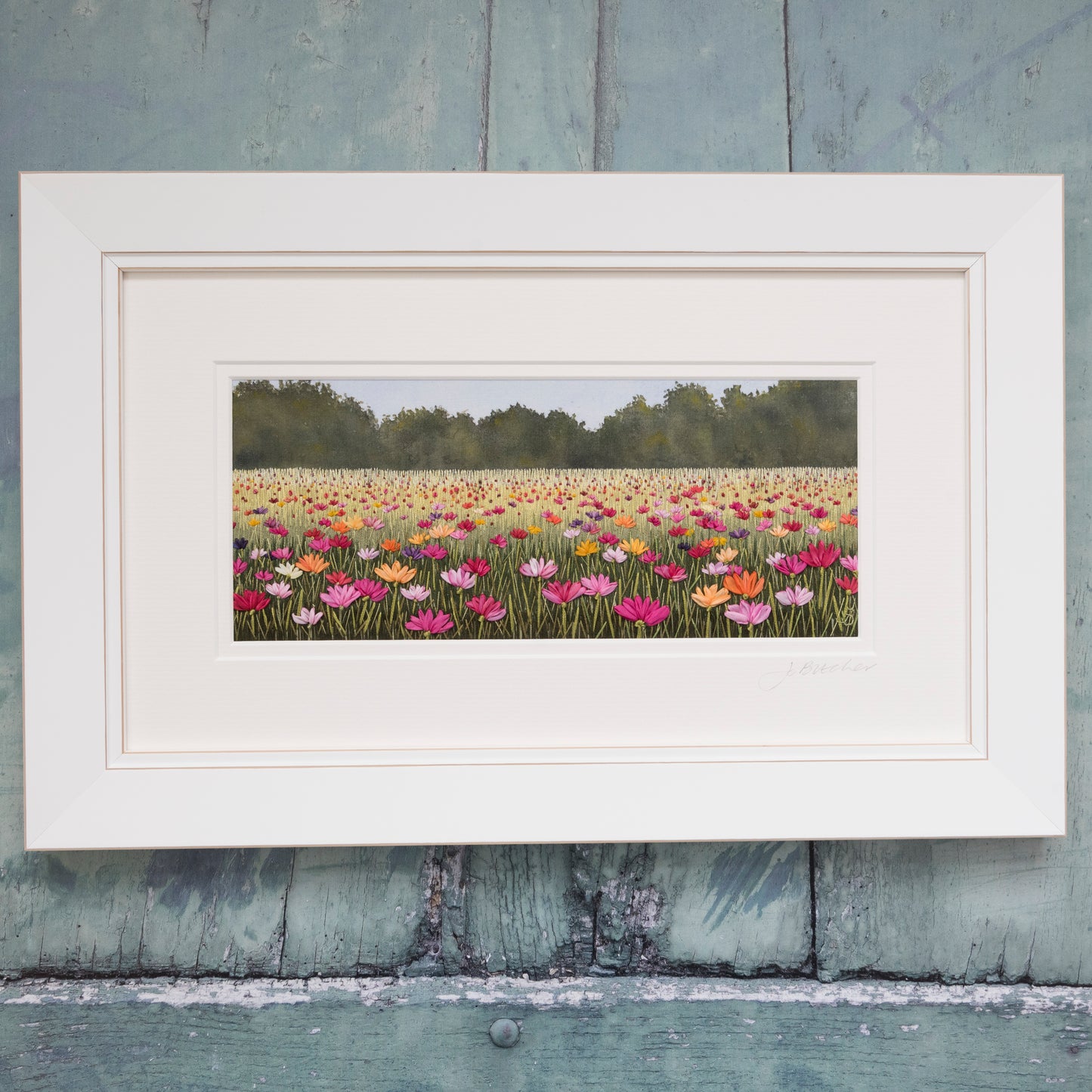 White framed embroidery artwork of a summer meadow.