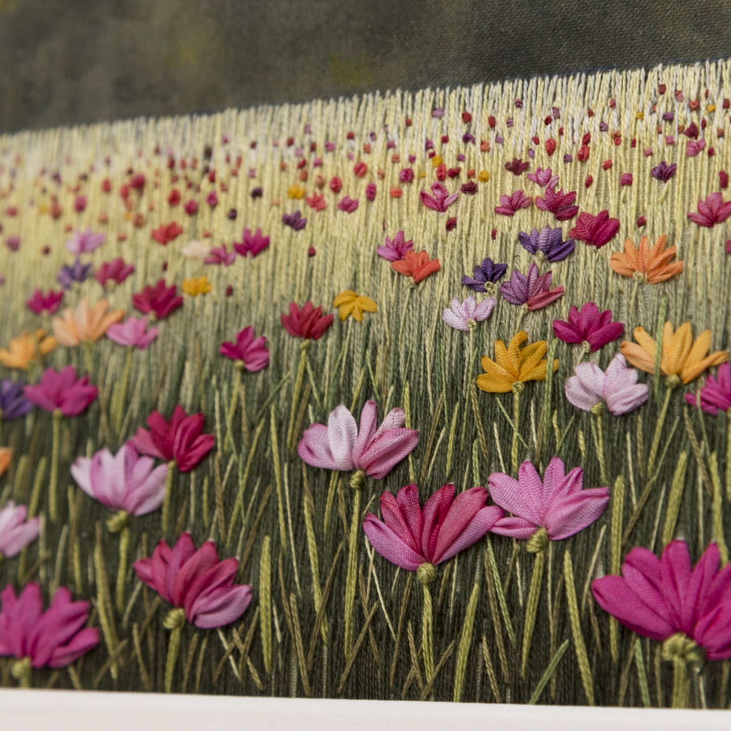 ribbon embroidery of colourful flowers on a embroidered and hand painted background.