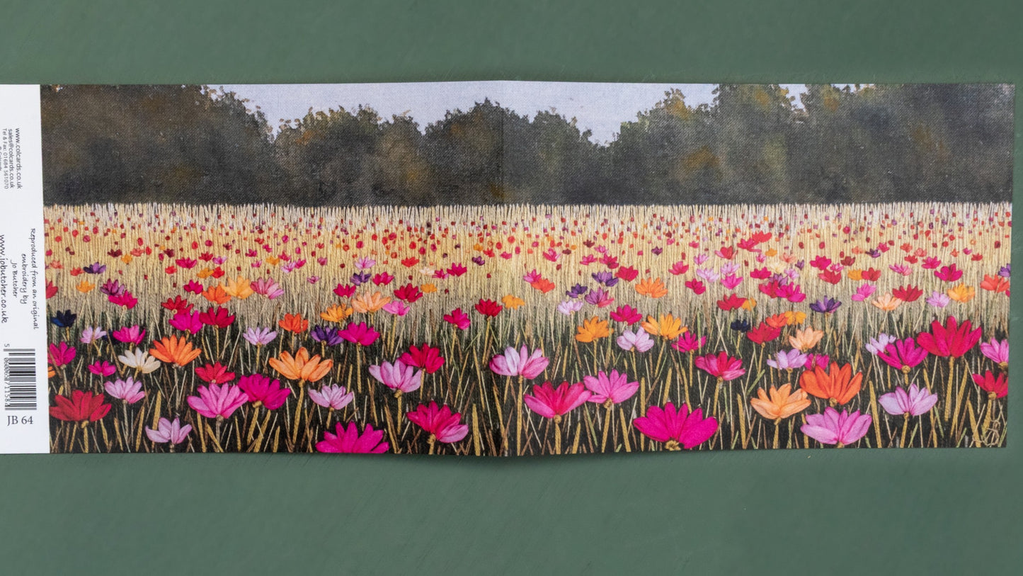 Bright poppies fill this summer meadow all the way to the distant hedges