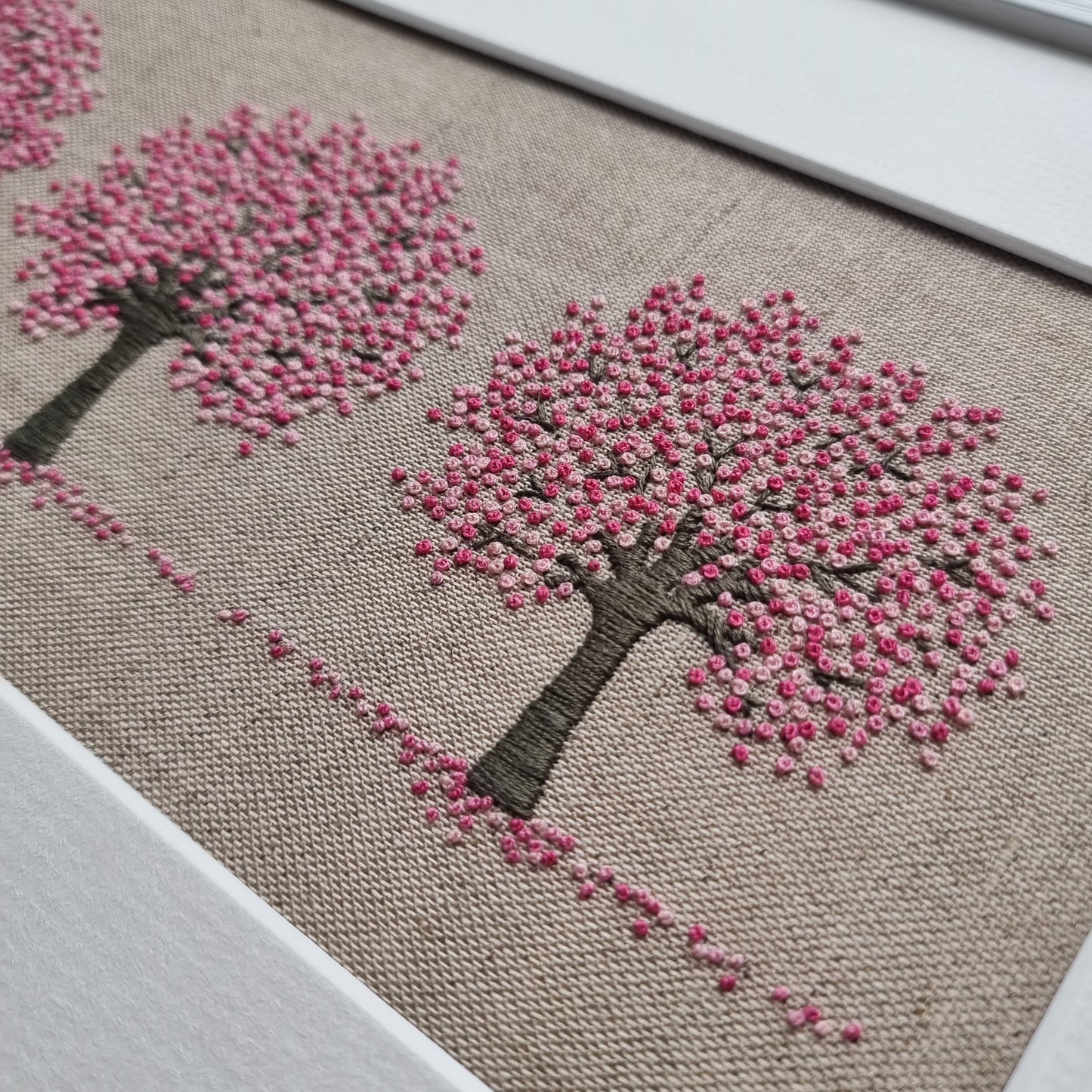 Three cherry trees on a beige Cotton/linen background