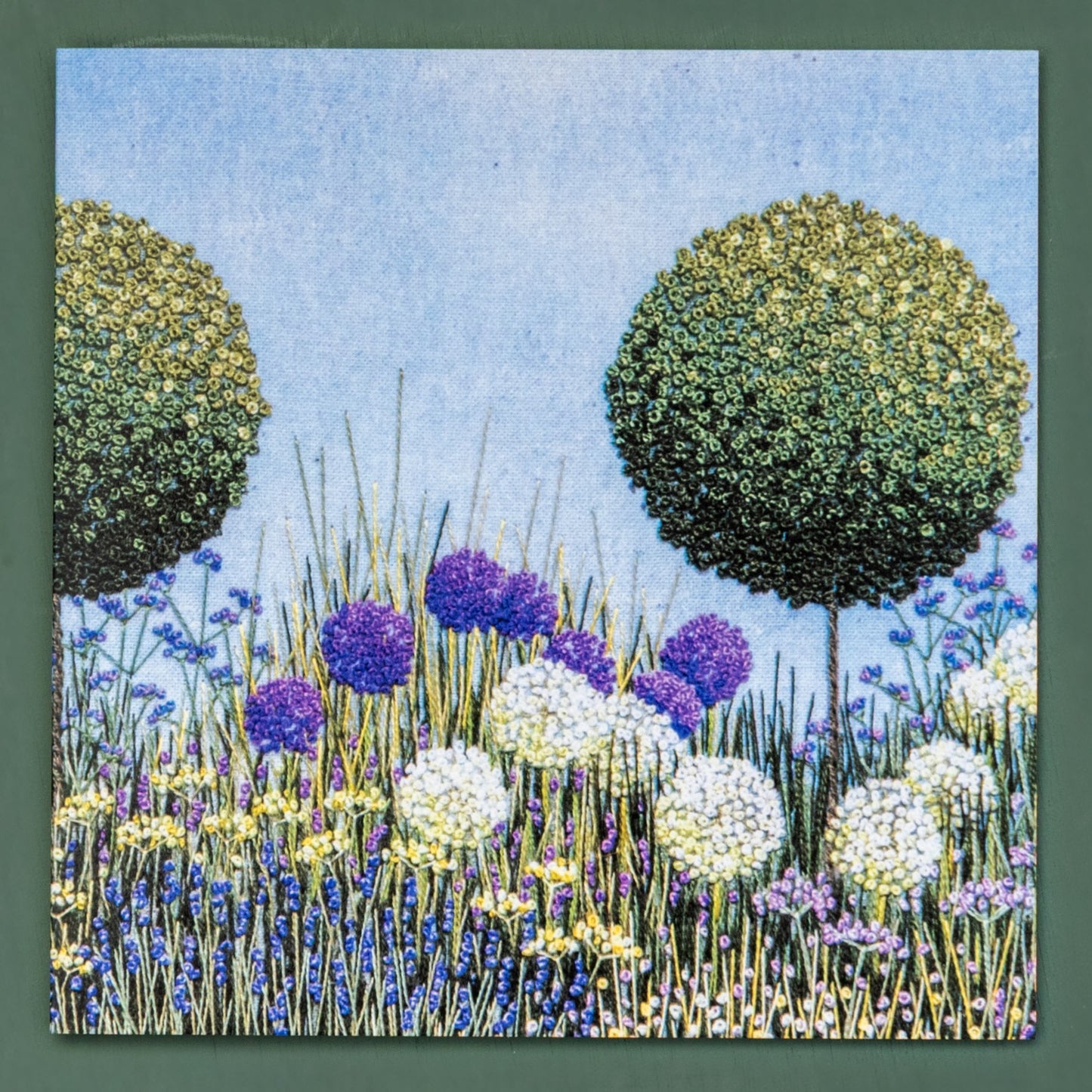 front of card of topiary trees and alliums