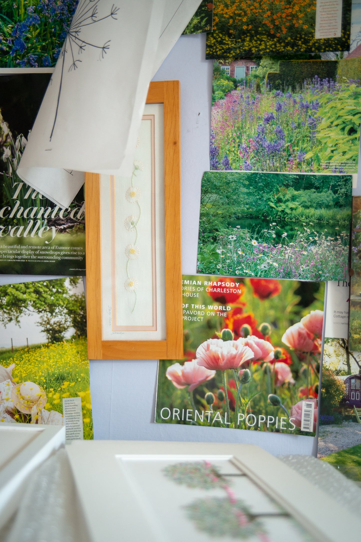 frames artwork and magazine pictures staged on pinboard