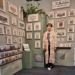 Jo standing on her stand at the knitting and stitching show at Alexandra Palace