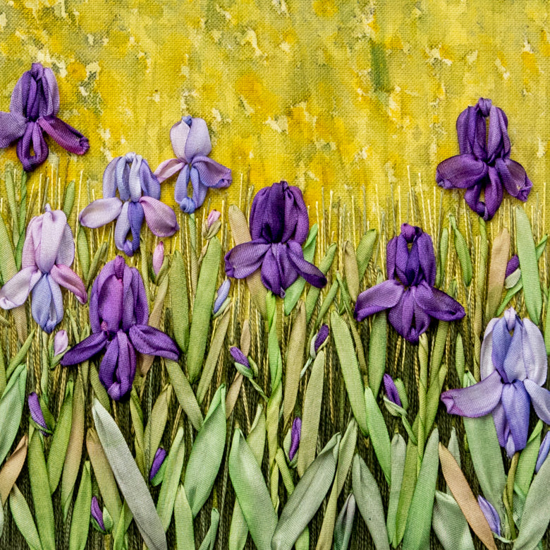 purple irises and foliage embroidered using silk ribbons on a painted background