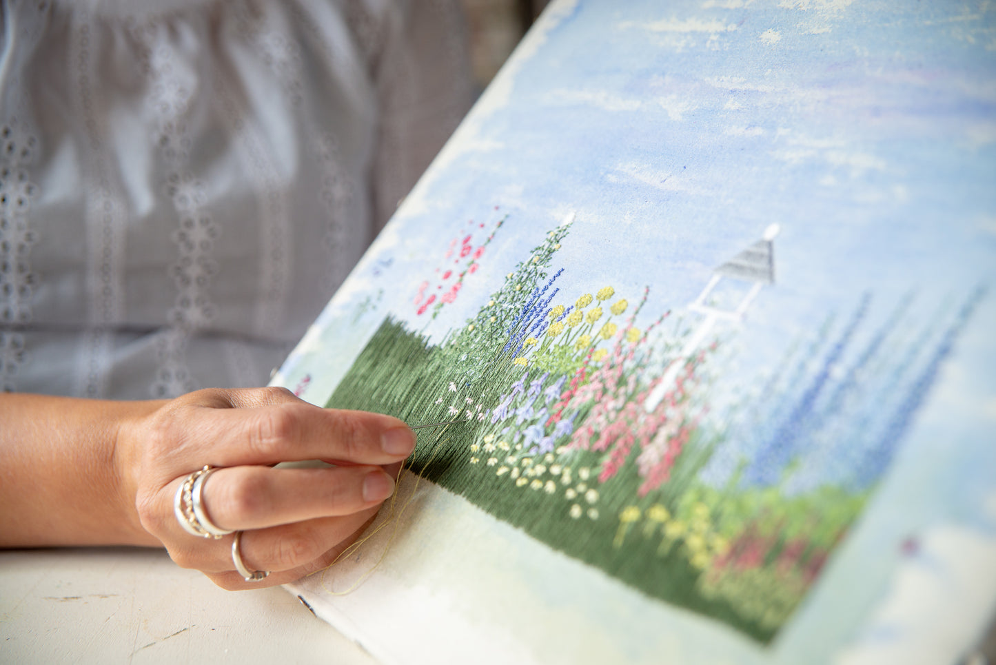 close up of jo's hand embroidering