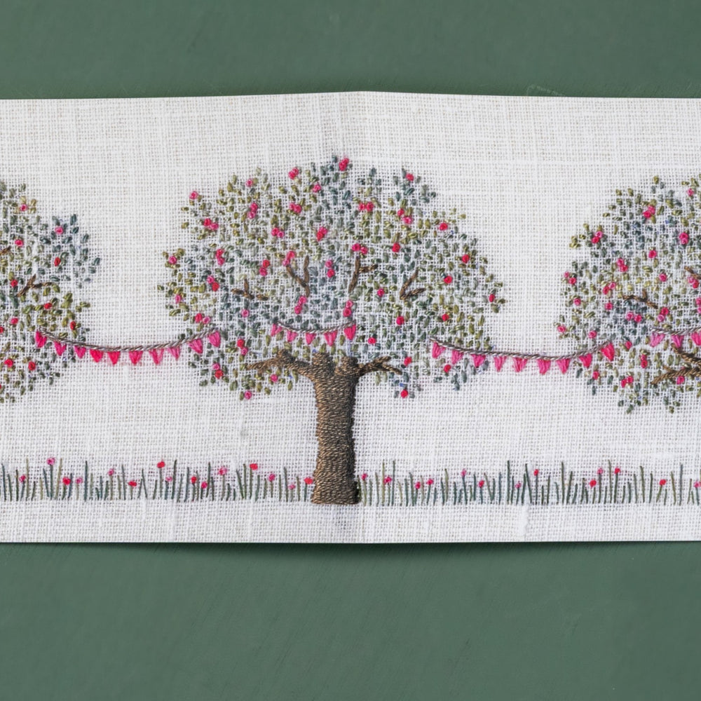 This card when open shows three hand embroidered apple trees with pink blossom. Draped between them is pretty matching pink bunting.