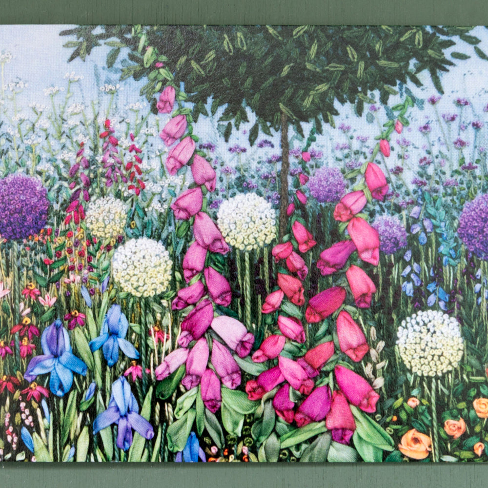 Colorful garden scene with various flowers on a card