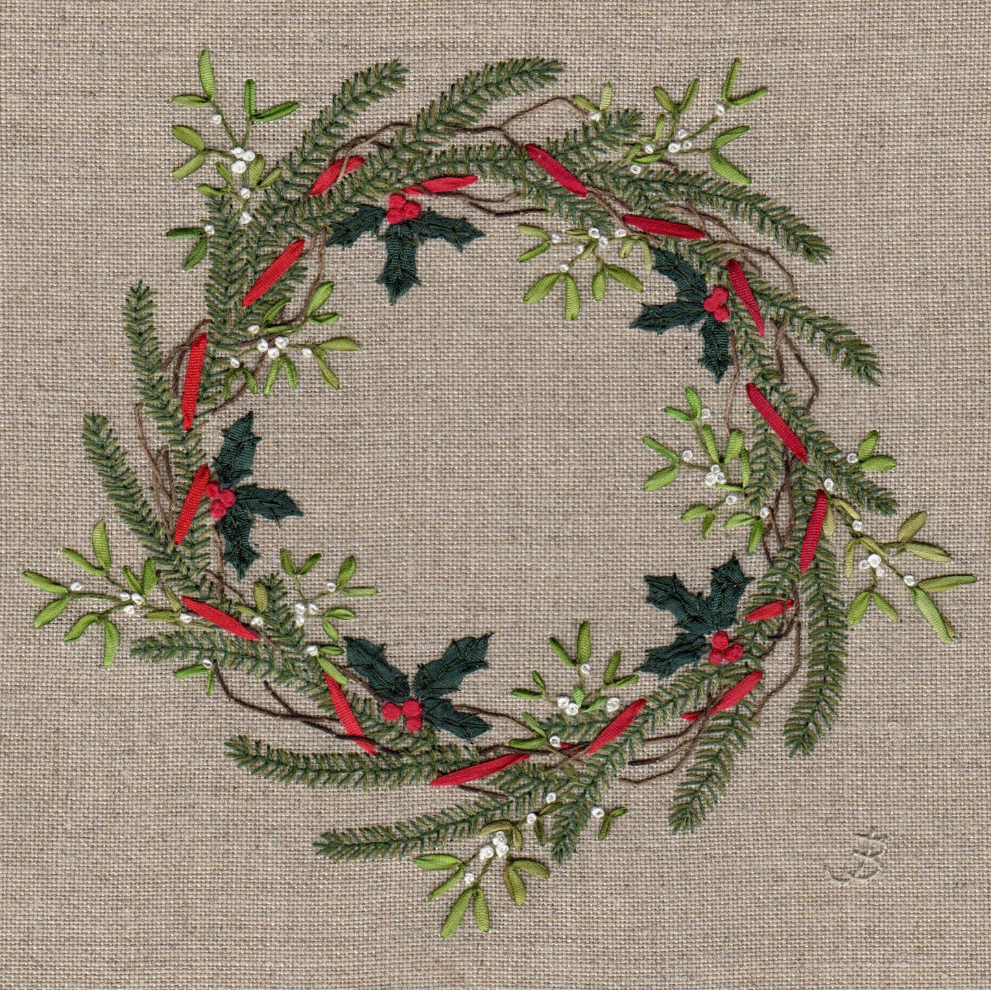 A embroidery of a Christmas wreath made form holly, mistletoe with white berries, and sprigs of fit tree and other foliage