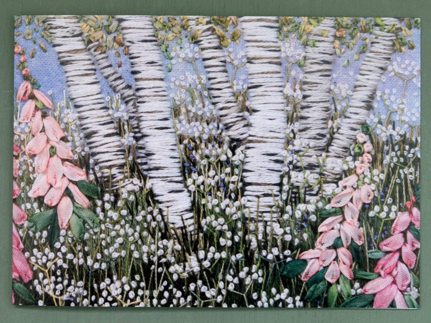 Card printed from a Jo Butcher hand embroidered original depiction of a clump of silver birch trees rising above a meadow of foxgloves and cow parsley