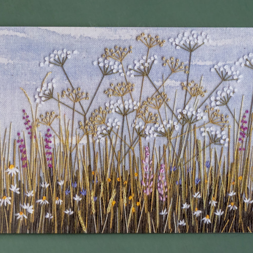 Hand embroidered classic of a rabbit's eye view of a meadow.