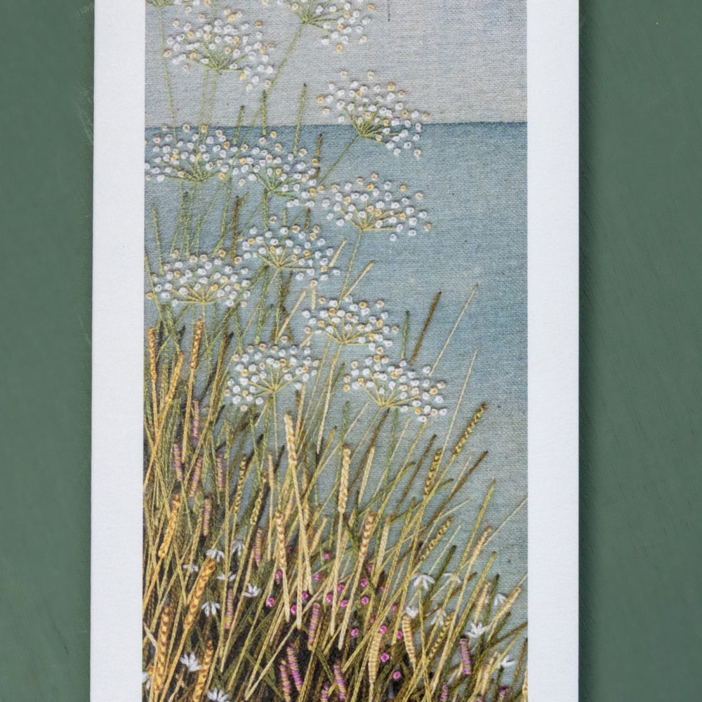 Upright card of a cliff top coastal scene.