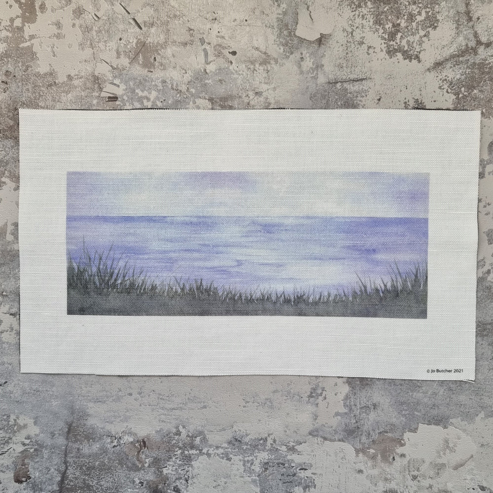 A printed cotton linen rectangle with the view f the horizon from a cliff with grasses printed in the lower third on the image for sewing over.