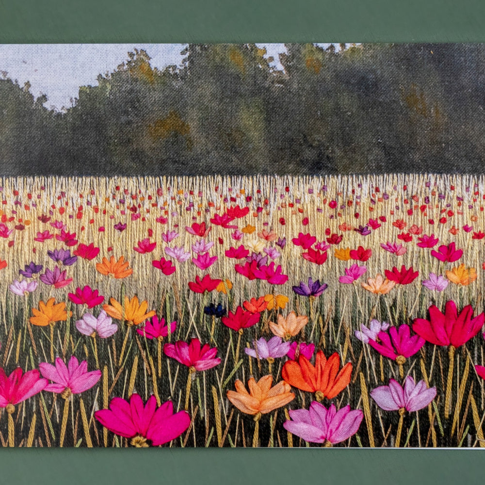 A summer meadow full of bright poppies receding into the distance.