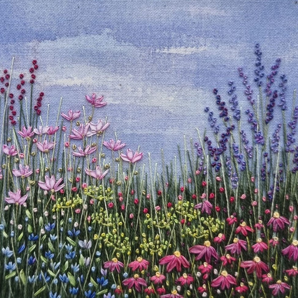 embroidery of a summer border on a painted background. The flowers are a range of colours and stitched using cottons or silk ribbons